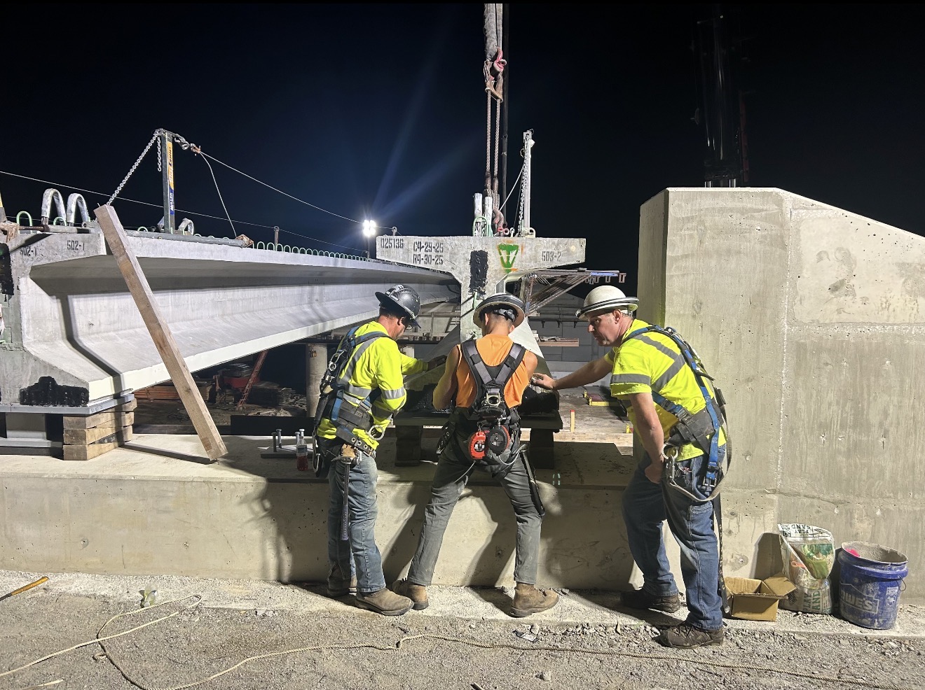Eagle Bridge crew setting precast beam at night